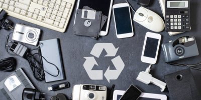 Old electronic devices on a dark background. The concept of recycling and disposal of electronic waste