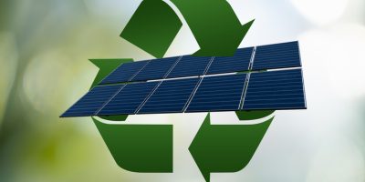 Solar panel with green recycling symbol.